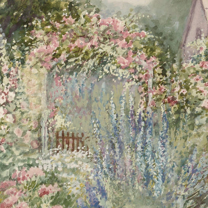 Floral archway with pink flowers and greenery in a garden setting