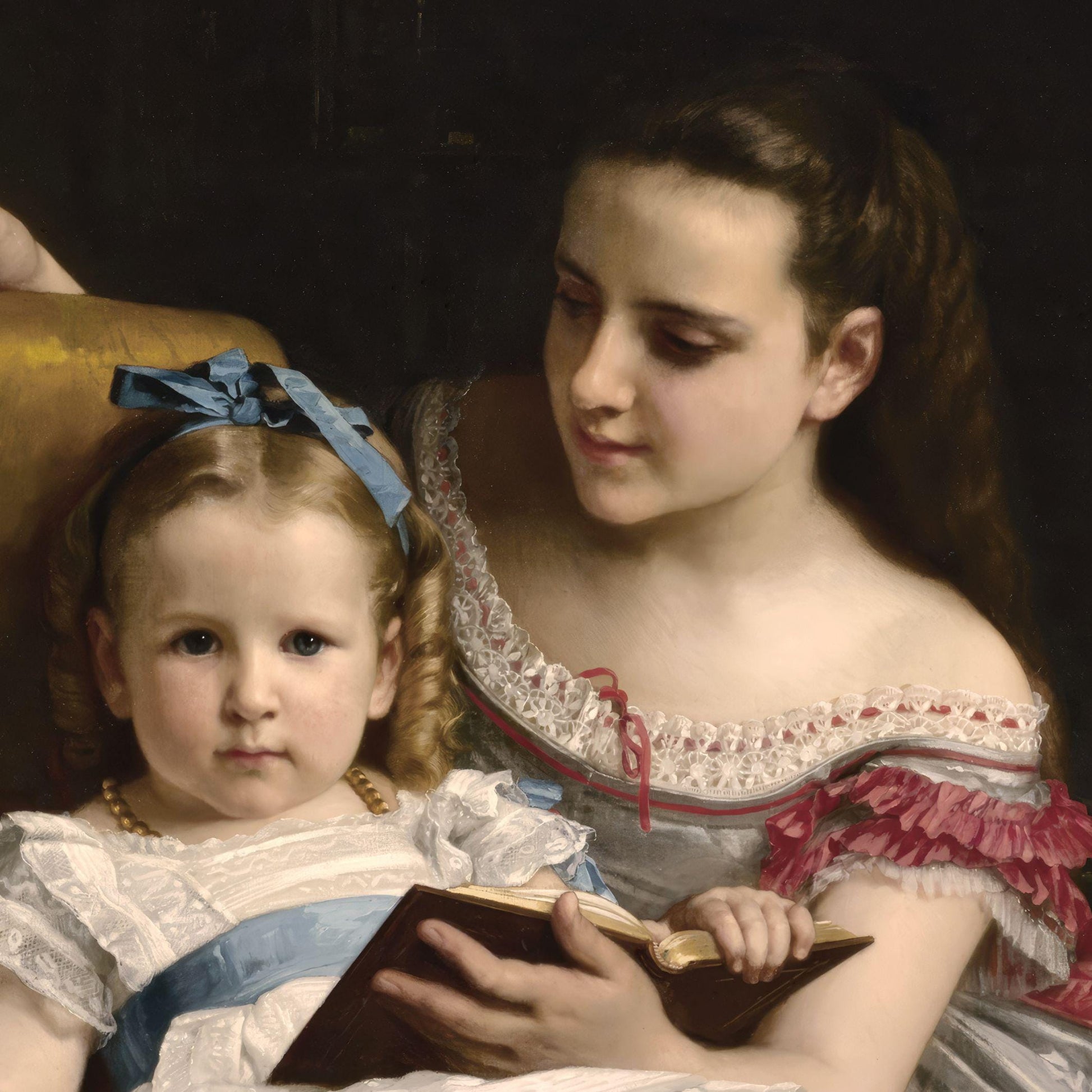 Portrait of a woman and a child holding a book against a dark background