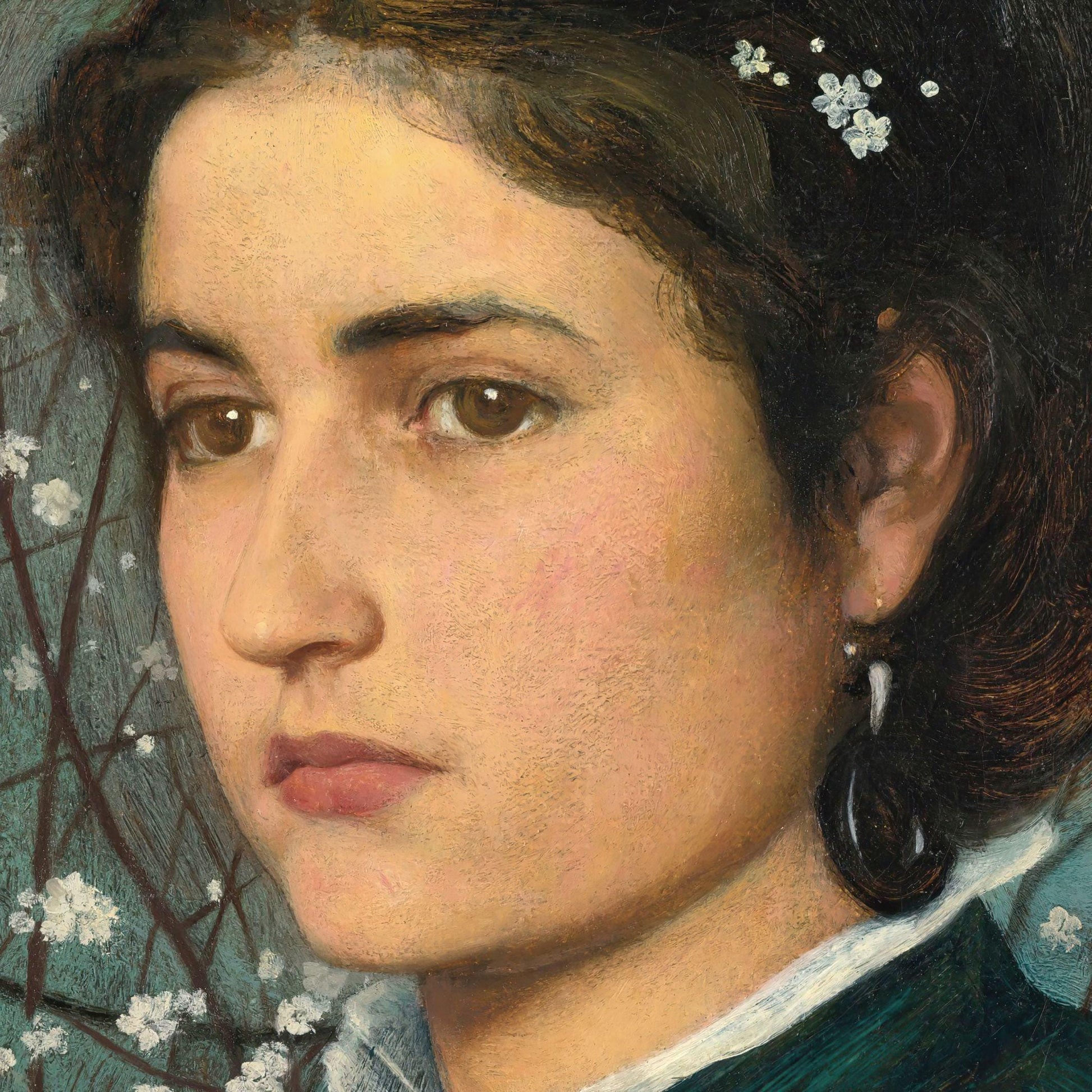 Close-up of a woman's face with flowers in her hair, wearing a blue garment.