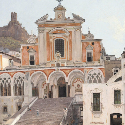 Historic building with ornate architecture and steps leading up to it, set against a mountainous background.