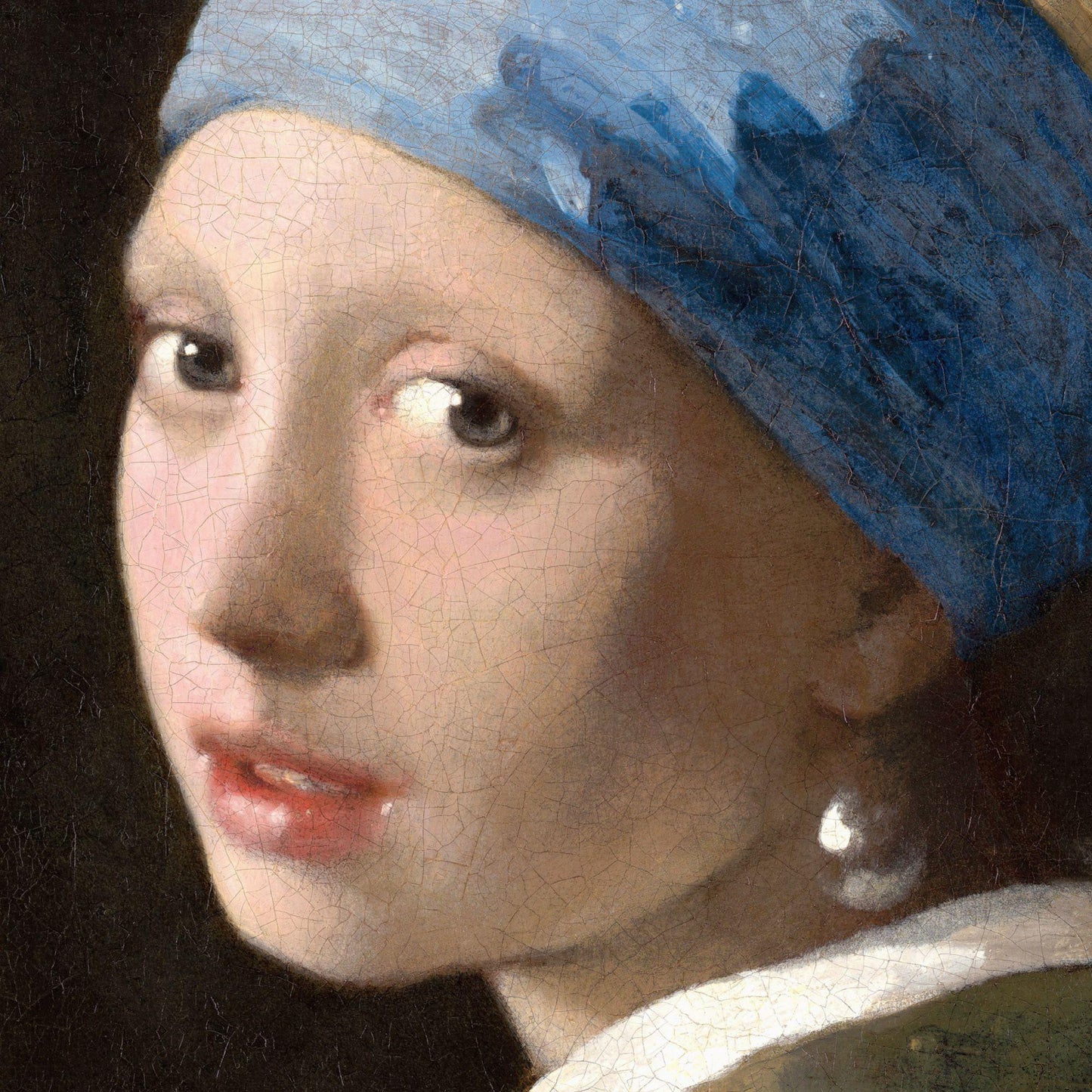 Close-up of a painting of a woman wearing a blue headscarf and pearl earring.