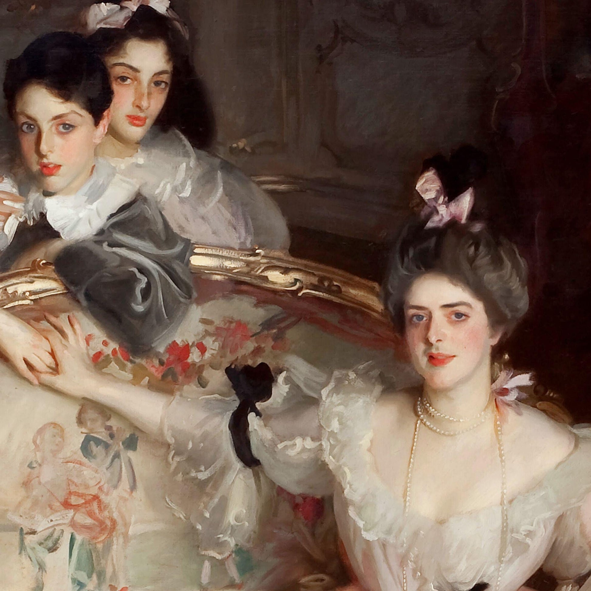 Portrait of two women in formal attire with a decorative mirror in the background