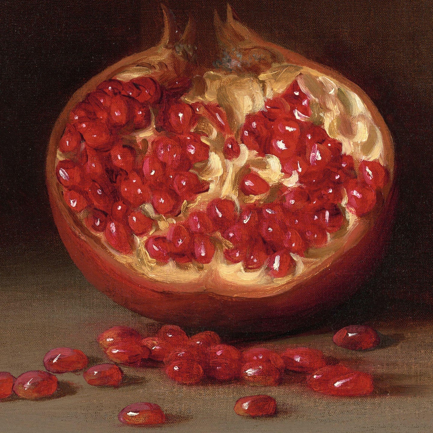 Pomegranate with seeds spilling out on a dark background