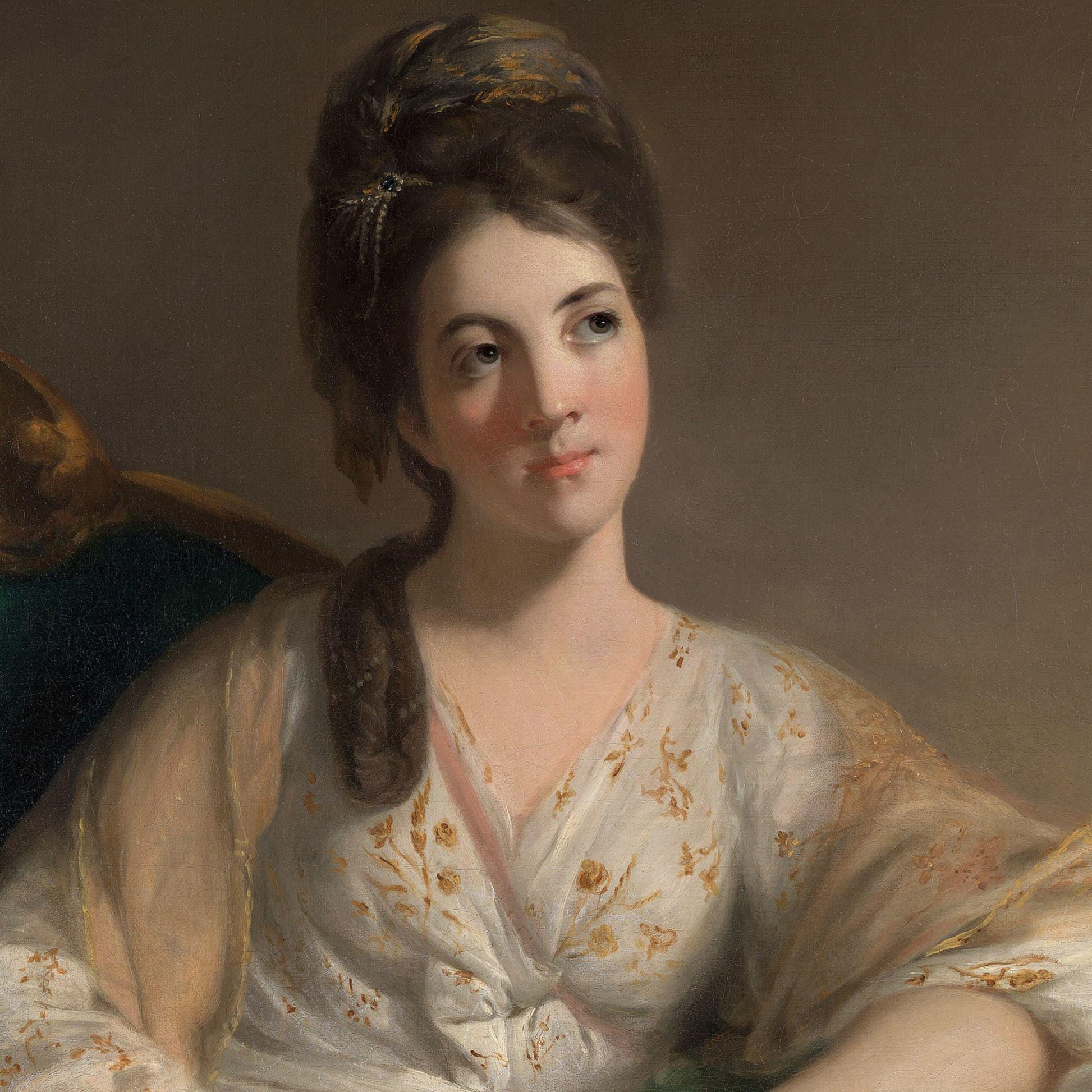 Portrait of a woman in a white dress with floral pattern.