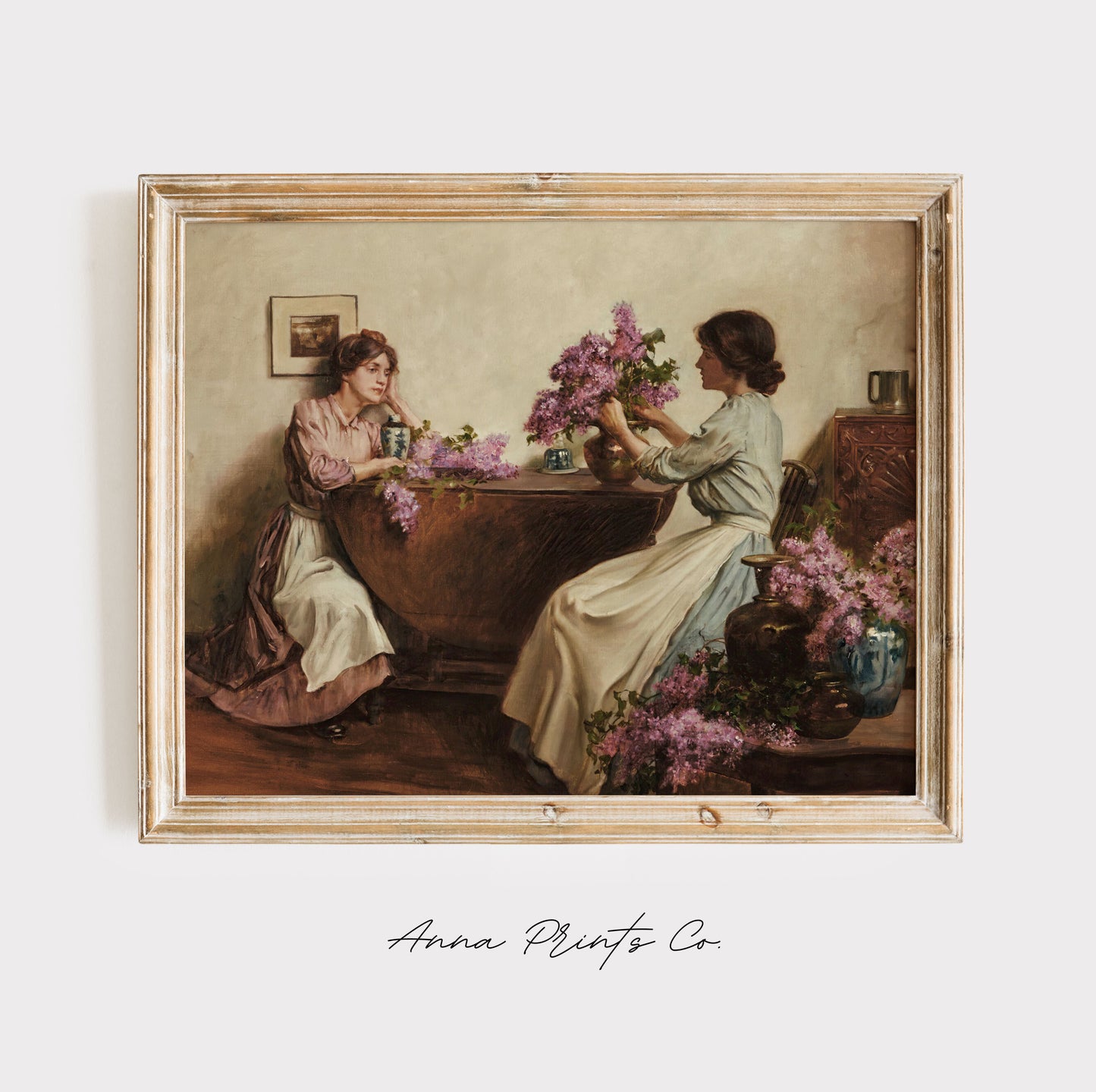 Vintage art print of Women Arranging Flowers Painting displayed in wooden frame