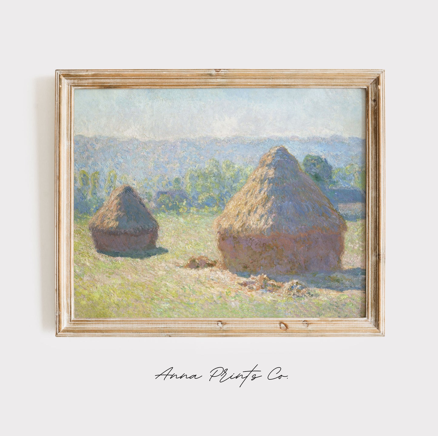Vintage art print of Haystacks, end of Summer by Monet displayed in wooden frame