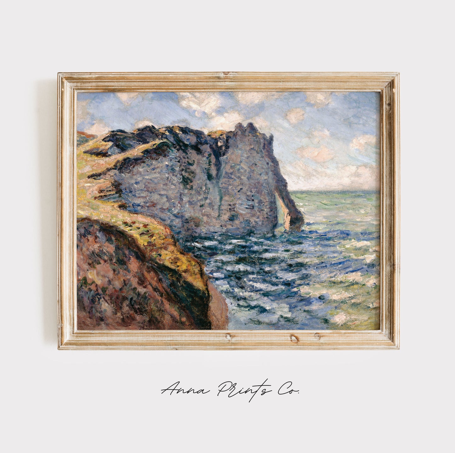 Vintage art print of The Cliff of Aval, Etretat by Monet displayed in wooden frame